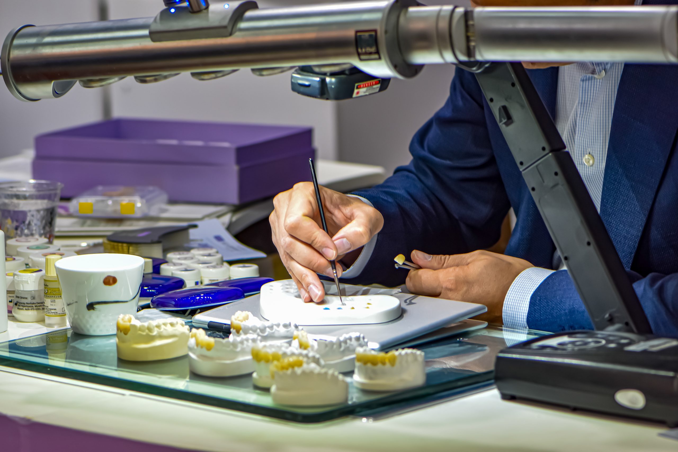 a person working on a model of teeth