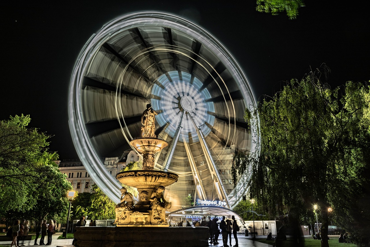a ferris wheel with a statue and a fountain