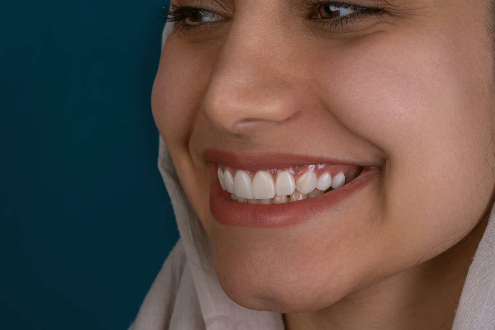 Close-up of woman smiling with even, white teeth and healthy gums